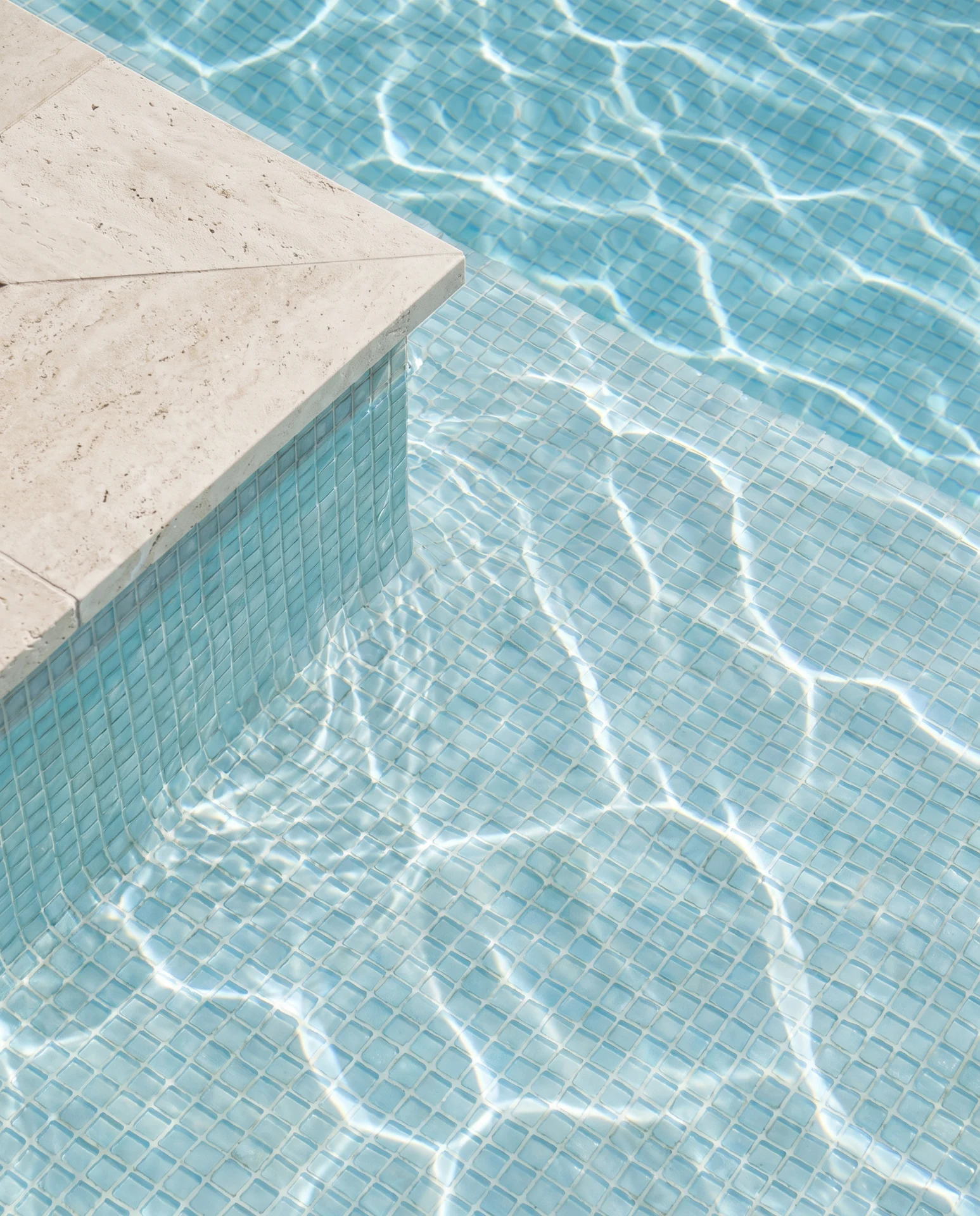 Illustrative blue pool water and the texture of reflected light